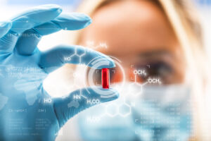 Young,Attractive,Female,Scientist,Holding,A,Red,Transparent,Pill,With
